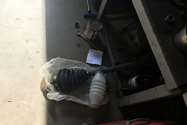 A modern TPEE CV boot next to a cracked traditional rubber one.